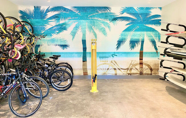 a group of bikes parked in front of a wall mural of a beach with palm at La Jolla Blue, San Diego, CA