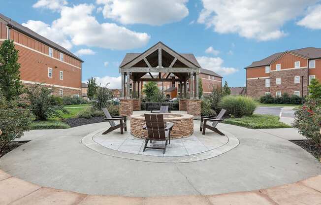 an outdoor patio with a fire pit and a gazebo