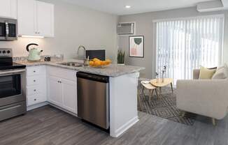 A modern kitchen with a dining area.