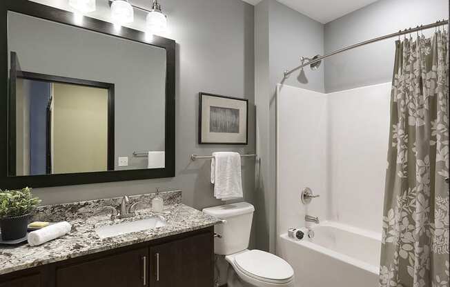 Spacious Bathroom with Granite Countertop Vanity