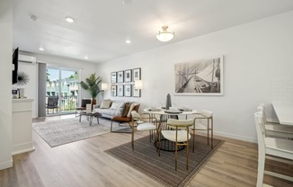an open living room and dining room with a table and chairs