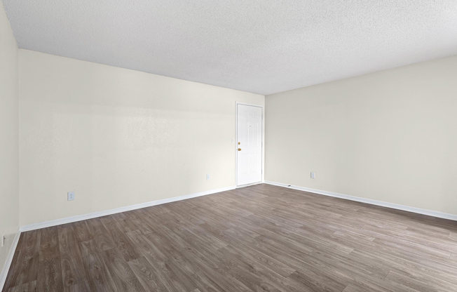 Front entrance and gold living room at The Arbor Apartments in Blue Springs, Missouri