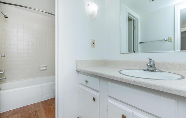 bathroom with white cabinets