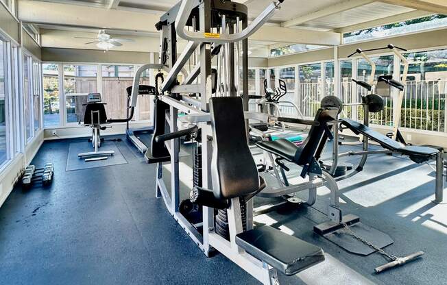 a gym with weights and cardio equipment on the floor