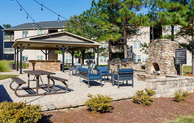 A patio with a table and chairs under a canopy.