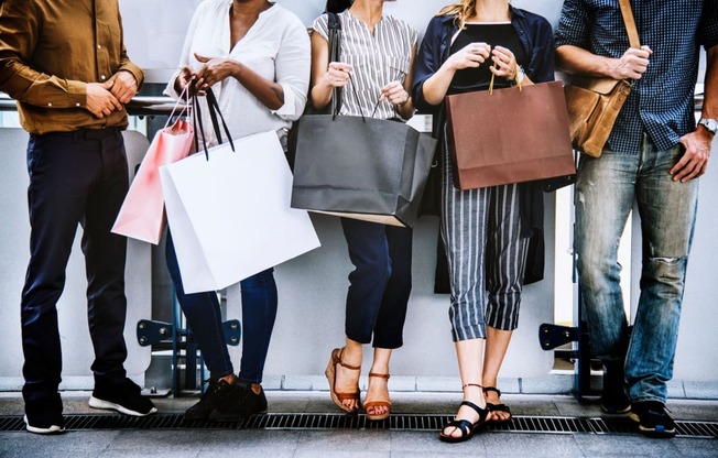 a group of people holding shopping bags
