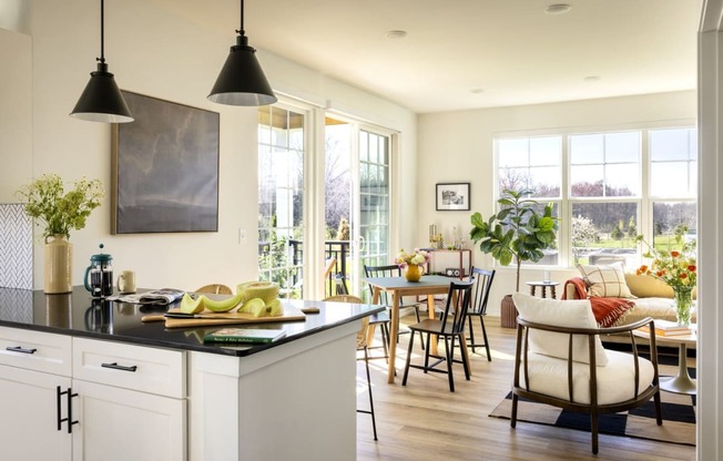 a kitchen and living room with a table and chairs