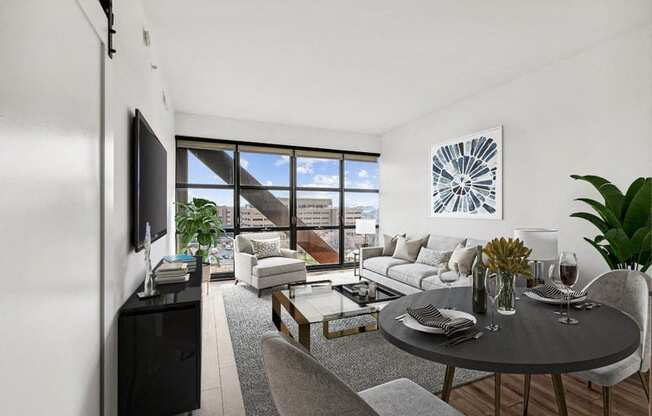 an apartment with a living room and a dining room with a couch and a table