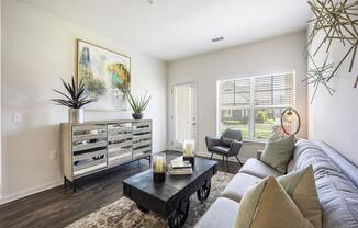 a living room with a couch and a coffee table at The Maddox Apartments, Arkansas