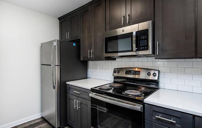 a stove top oven sitting inside of a kitchen
