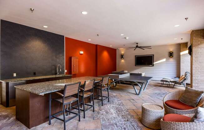 A modern kitchen with a bar area and seating.