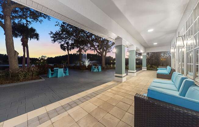 Community Patio Area with Lounge Furniture at Vinings at Hunter's Green Apartments in Tampa, FL.