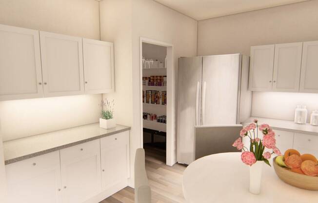 a kitchen with white cabinetry and a table with a vase of flowers on it at Brownstones at Palisade Park, Broomfield, 80023