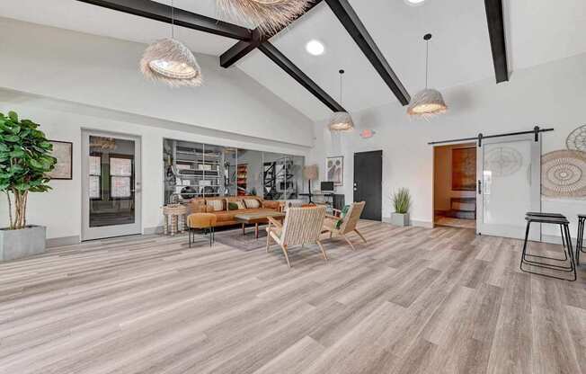 A living room with a wooden floor and a large window.