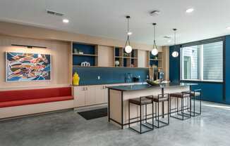 a kitchen with an island and stools in front of a table and a couch