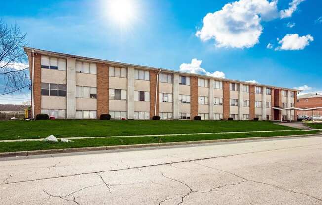 an apartment building with a street in front of it