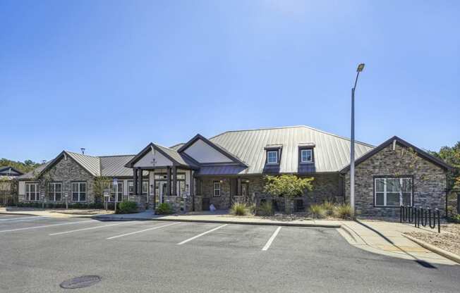 Front of the leasing office with parking for future residents at Evergreen at Southwood in Tallahassee, FL