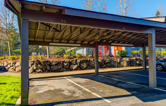 a parking garage with a roof over a parking lot