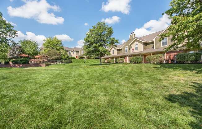 a large yard with a house in the background at Highland Ridge Apartments, Kansas