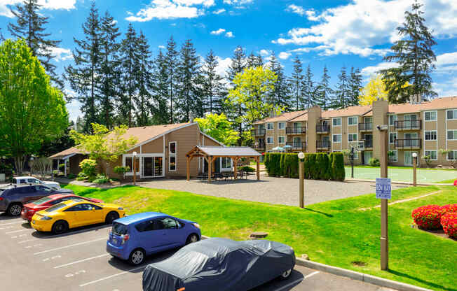A parking lot with cars and a building in the background.