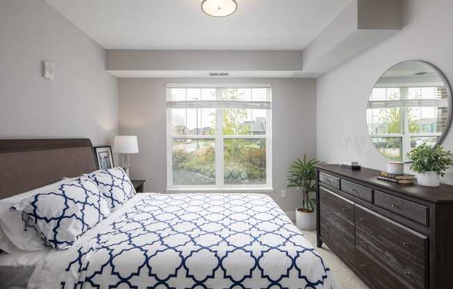 a bedroom with a large bed and a large window