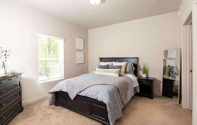 a bedroom with a large bed and two night stands