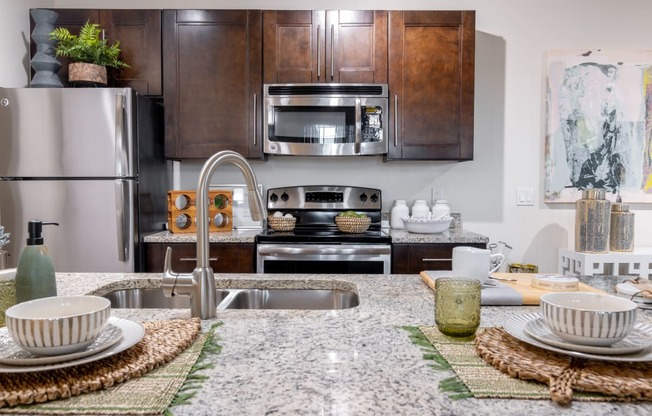 a kitchen with stainless steel appliances and granite counter tops