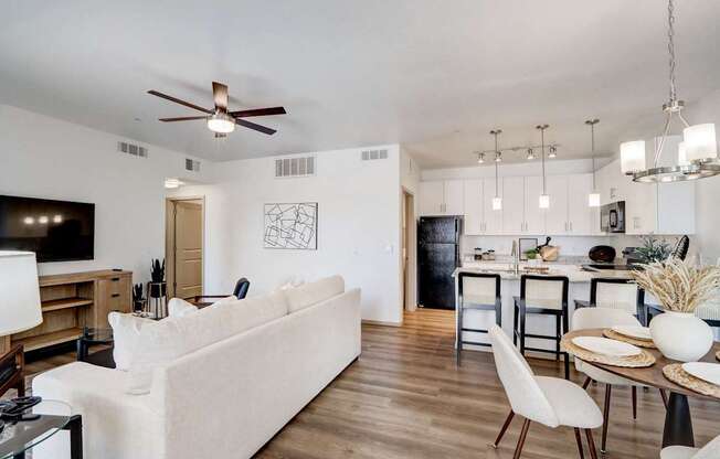 A modern living room with a white couch and a television.