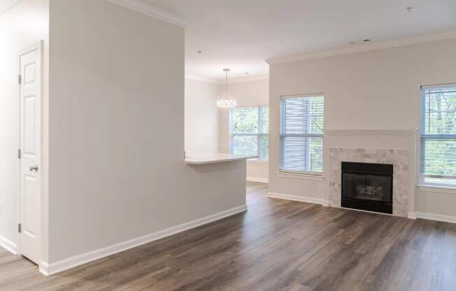 a living room with white walls and a fireplace