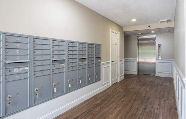A row of mailboxes are lined up on a wall.