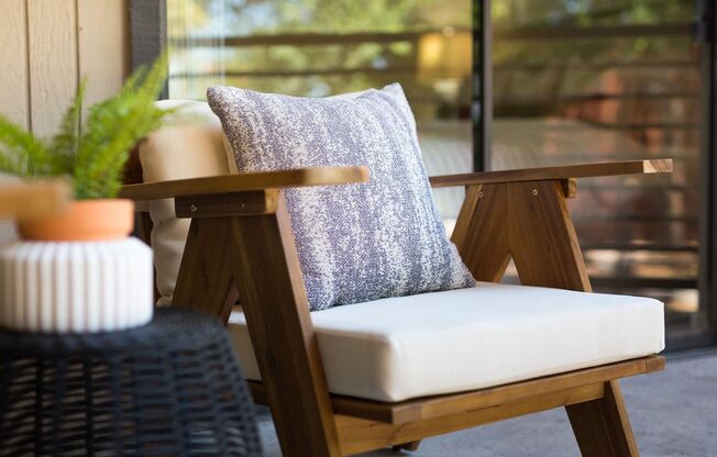 a chair with a cushion on it on a patio