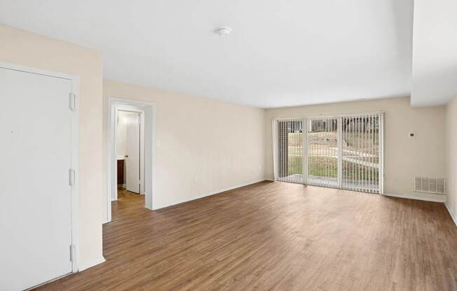 A room with wooden floors and white walls.