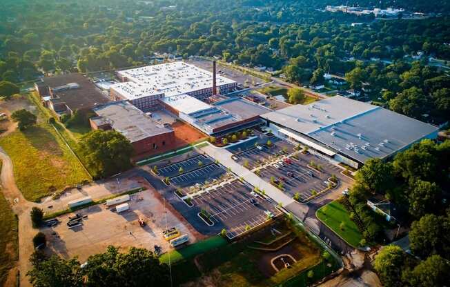An aerial view of a large building complex surrounded by trees.