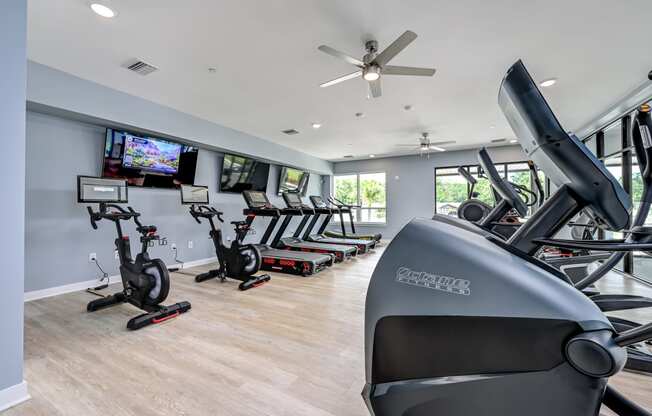 a gym with treadmills and other exercise equipment