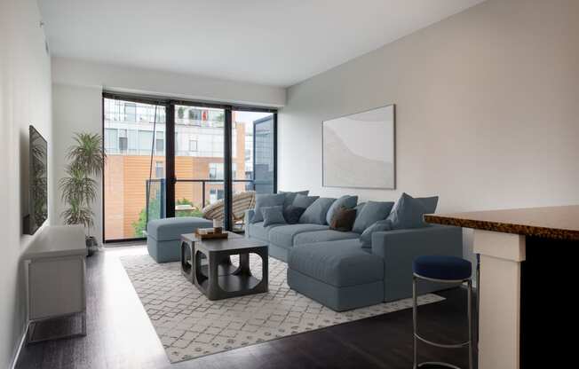 a living room with a blue couch and a coffee table
