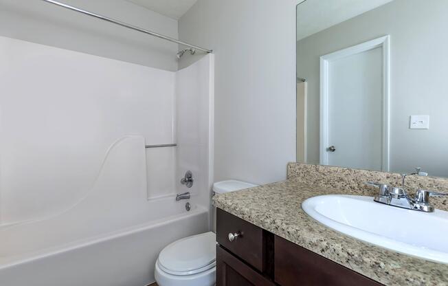 a room with a sink and a mirror