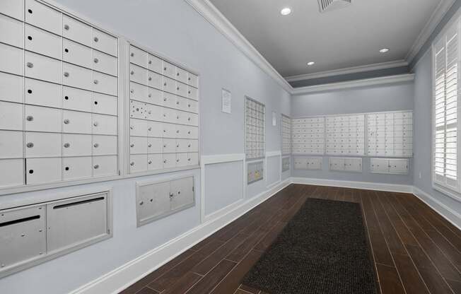 A room with a black carpet and wooden floors.