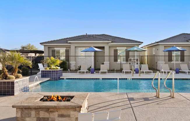 A pool with a fire pit in the middle of it.