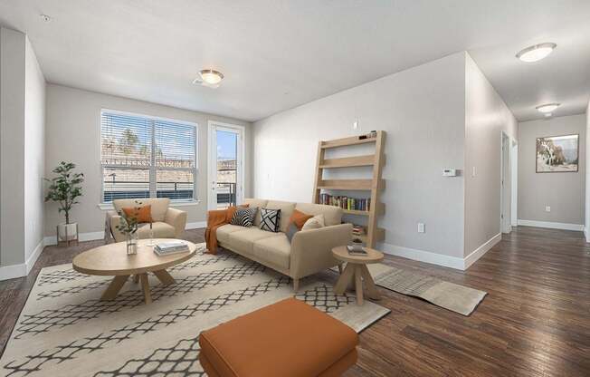 A living room with a couch, a chair, a coffee table, and a rug.