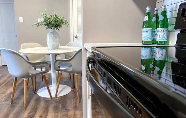 a kitchen with a table and chairs and a stove and a refrigerator