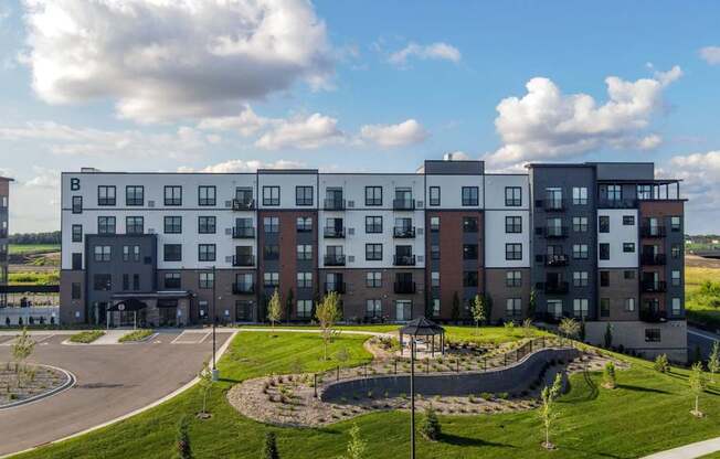 A large apartment complex with a playground in front.