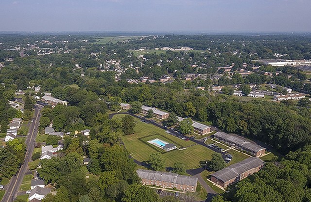 Aerial view of apartment grounds, swimming pool and surrounding neighborhood in apartments in Hatboro, PA