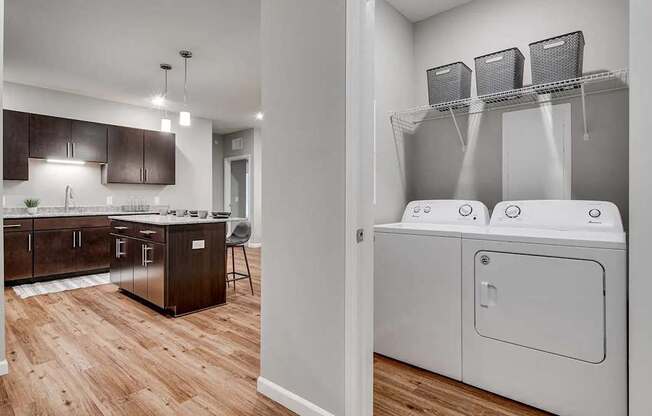 a washer and dryer in a room with a kitchen. Circle Pines, MN Lexington Lofts