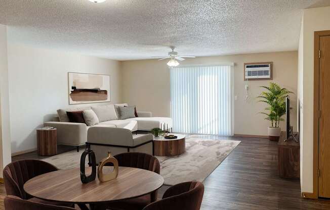 A living room with a brown table and chairs. Bismarck, ND Sierra Ridge Apartments
