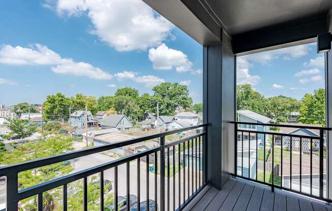 A balcony overlooks a residential neighborhood.