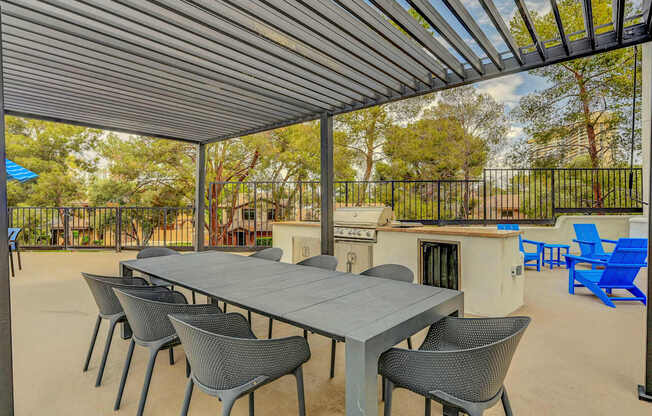 A patio with a table and chairs under a roof.