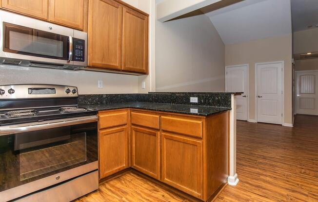 a kitchen with stainless steel appliances and wooden cabinets