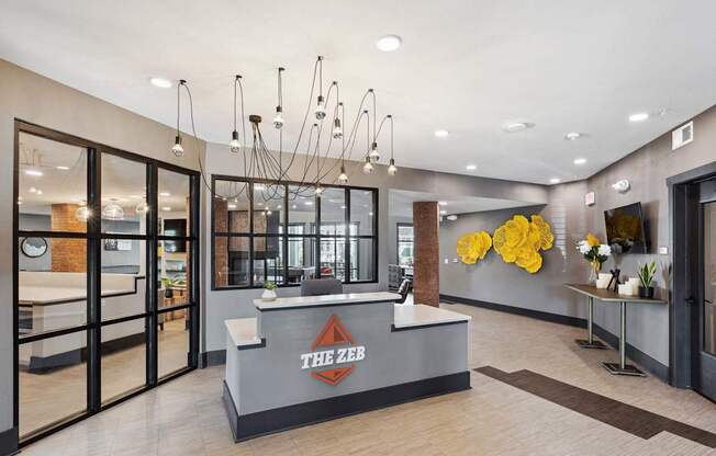 The lobby of a building with a reception desk and a clock on the wall.