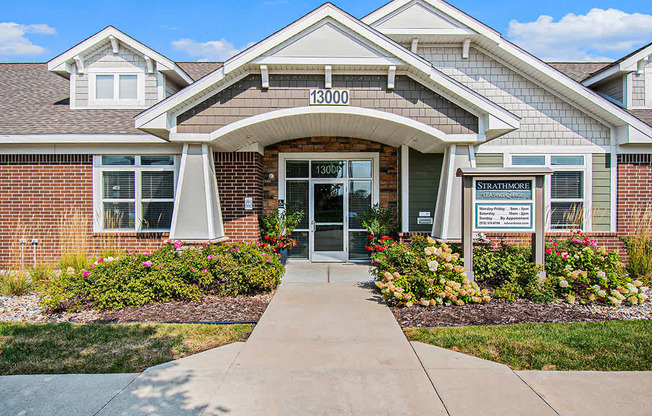 The front of a brick leasing office/community building/fitness center at Strathmore Apartment Homes, West Des Moines, IA