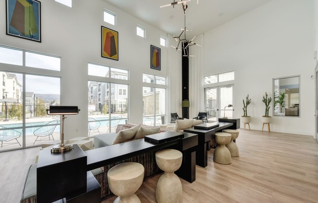 Inside Seating with Pool View , Long Black Desk, Wood Seats, Window and Hardwood Inspired Floor at Morgan Ranch Apartments, California, 95037